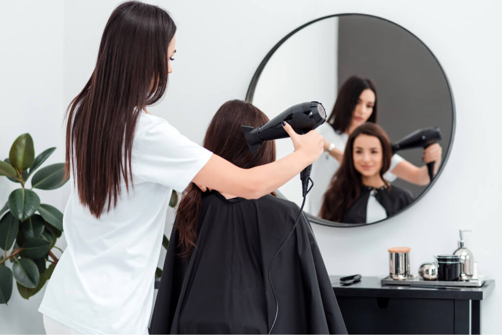 focused hairdresser works drying the hair of a bea 2021 09 24 04 23 52 utc.jpg